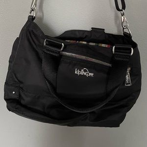 Kipling Black Bag with multi color interior. Great condition.